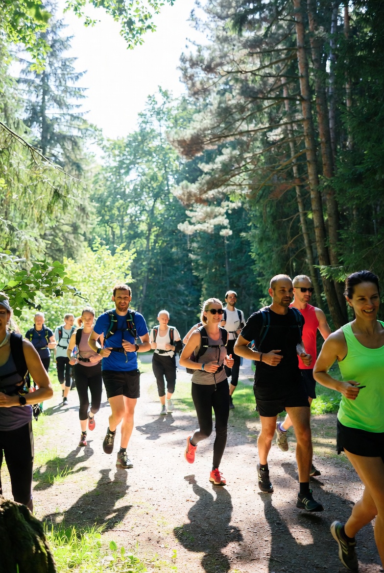Person stretching beside a work desk in a bright room
